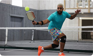 Player hitting a forehand shot during an indoor Texas Pickleball game