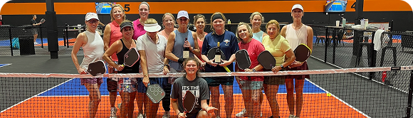 Texas Pickleball players celebrating community pickleball event indoors