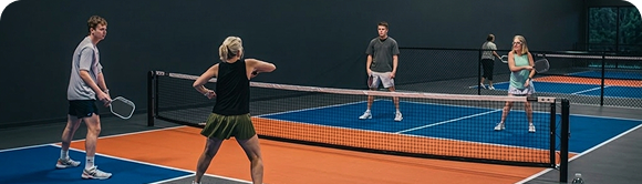 Texas Pickleball athlete practicing indoor pickleball skills on professional courts