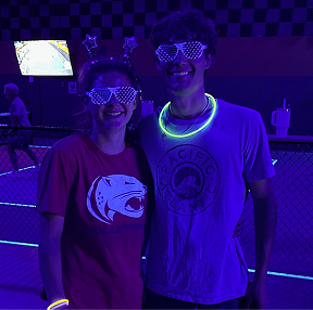 Texas Pickleball players wearing glow accessories during indoor pickleball party event