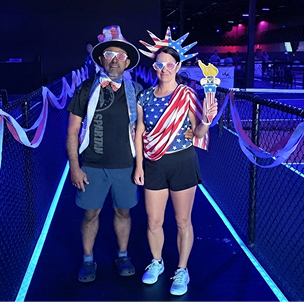 Texas Pickleball players celebrating themed pickleball event with patriotic outfits indoors