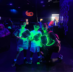 Texas Pickleball glow night social event with players enjoying indoor pickleball activities